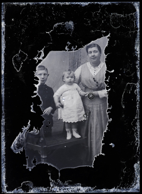 Staand portret, jonge vrouw met kleed in fijn geruite stof, 2 kinderen, 1 jongen en 1 meisje +/- 10 en 3 jaar, Melle, 1910-1920